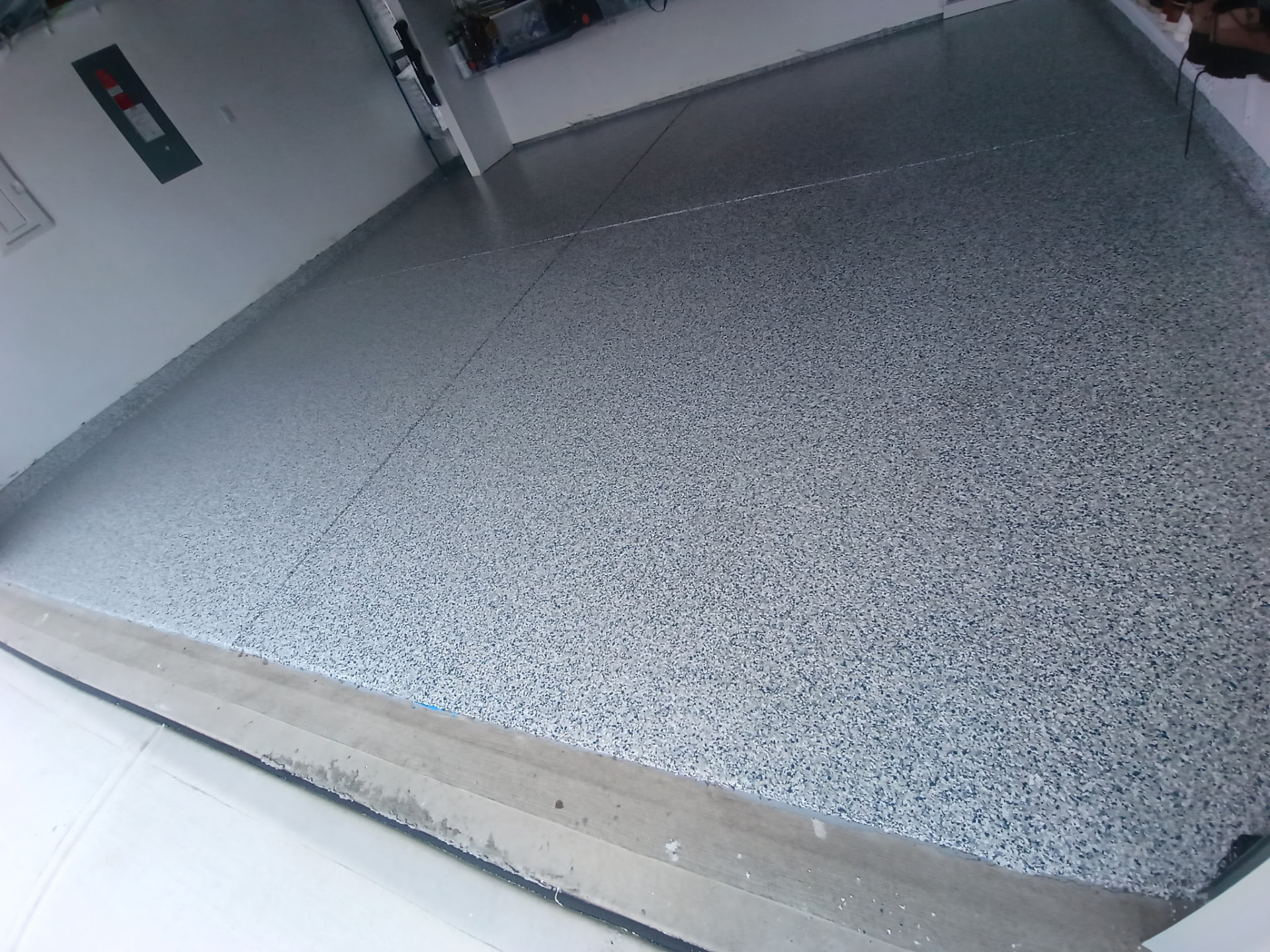 Grey and blue flake garage floor coating with coated lower walls