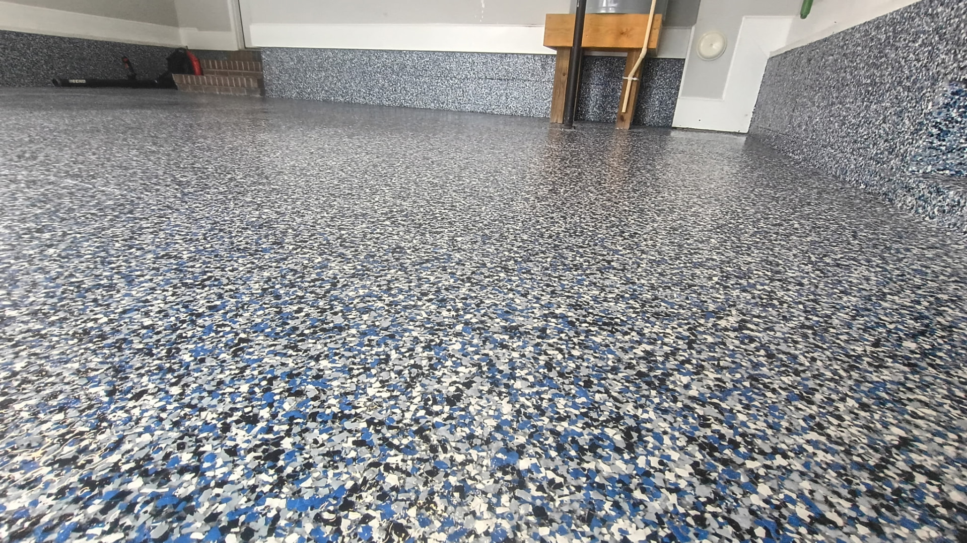 Blue, grey and white flake garage floor coating with coated walls
