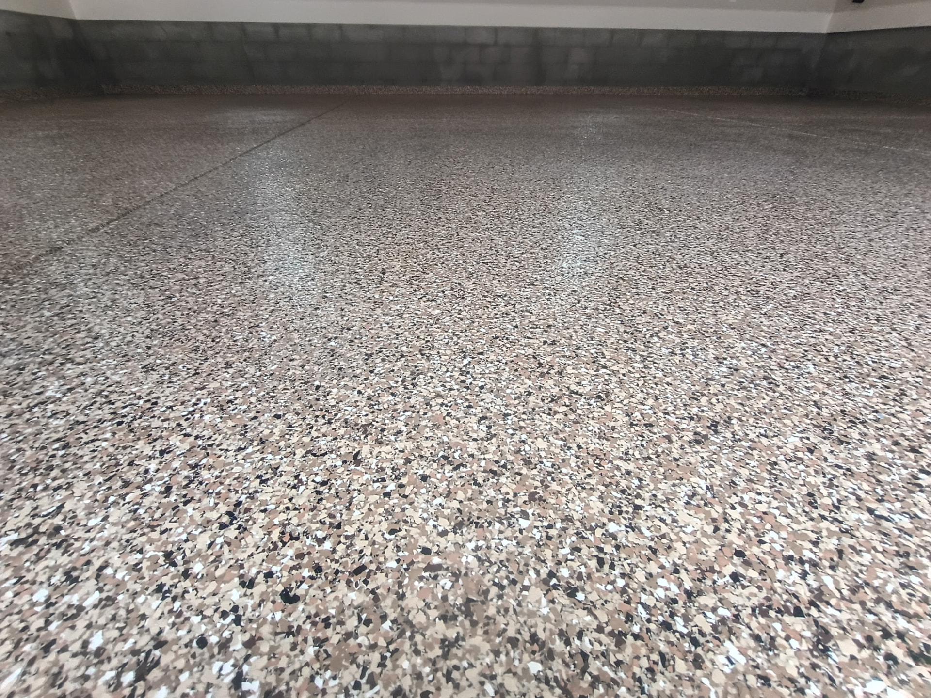 Tan and black flake garage floor coating